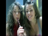Cute teens sucking on lollipops and strip teasing on camera